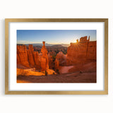 Extra large abstract art print of Bryce Canyon in textured red and orange tones on a gold-framed canvas.