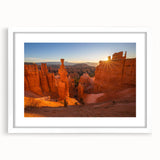 Abstract art print of Bryce Canyon in muted orange and red tones on a white-framed canvas.