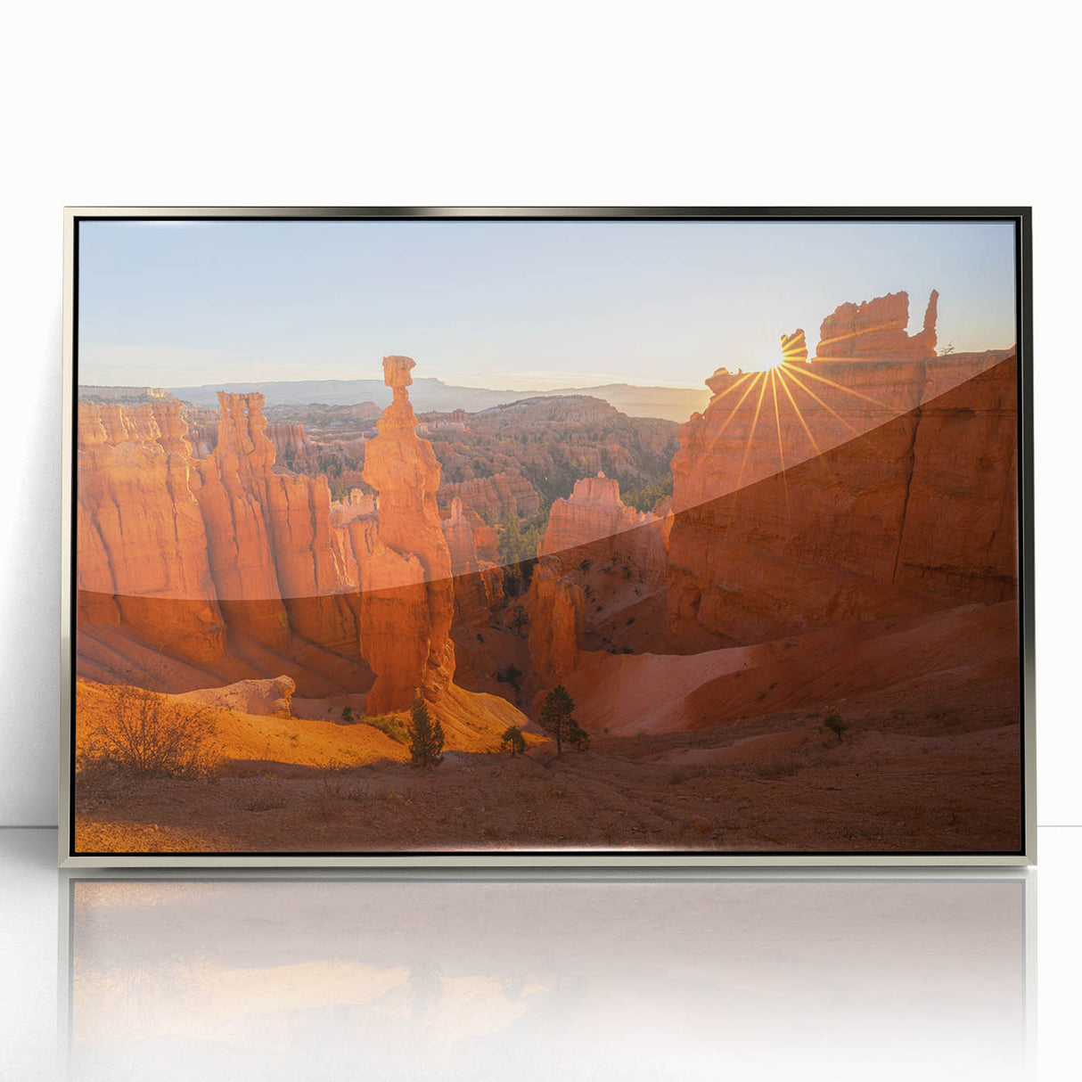 Mid-century modernist art depicting Bryce Canyon in muted earth tones on a silver-framed acrylic print.