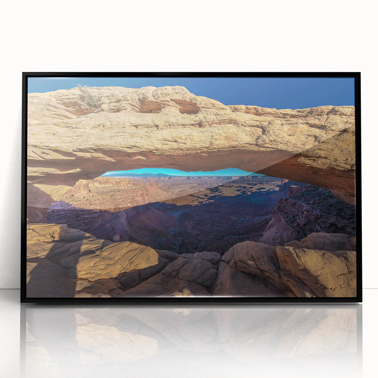 Large abstract wall art of Canyonlands with vivid orange and red tones on black framed acrylic.