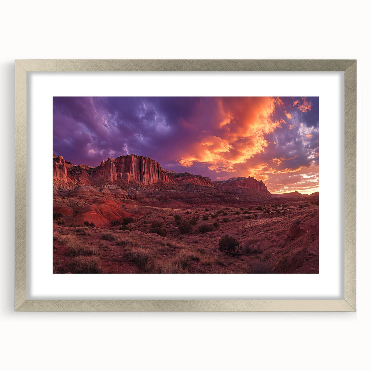 Textured art print of Capitol Reef in muted earth tones on a framed silver mat, ideal for bedroom decor.