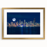 Extra large abstract art print depicting Seattle skyline in muted gray and blue tones, framed in gold.