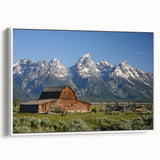 Vintage poster art of the Grand Tetons with a colorful background on a framed canvas.