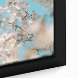 Close-up of a framed canvas featuring textured, colorful art depicting spring, with a black background.