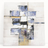 Abstract geometric stretched canvas leaning against a wall, showcasing vibrant colors of blue, orange, and yellow, perfect for modern home decor.