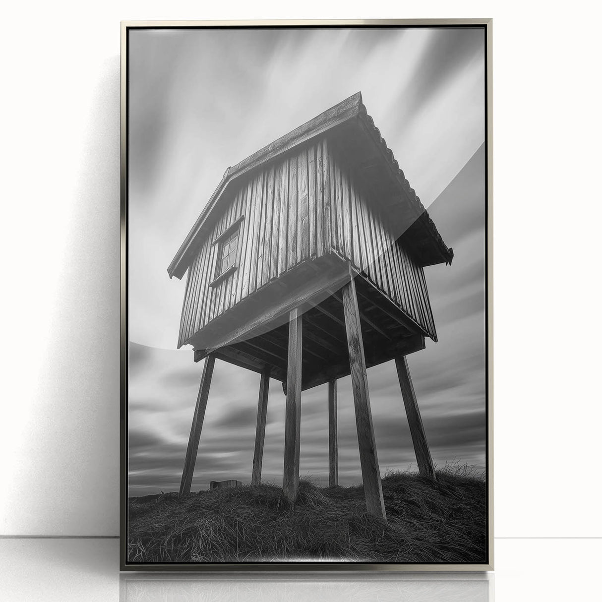 Mid-century modernist art depicting geometric shapes in neutral tones on a silver-framed acrylic print.