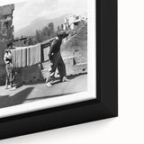 Close-up of black wall art depicting colorful, textured figures dining, on a framed canvas, suitable for living room decor.