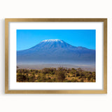 Textured abstract art print of a Kenyan landscape in muted earth tones, framed in gold, ideal for bedroom art.