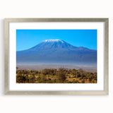 Abstract art print of a Kenyan landscape in muted earth tones on a framed silver mat, ideal for dining room decor.