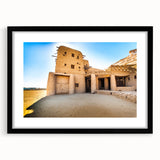 Extra large abstract art print depicting a colorful Moroccan landscape on textured canvas, framed in black.