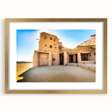 Textured art print featuring abstract Moroccan scenery in earth tones on a gold-framed mat, ideal for bedroom art.