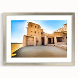 Abstract art print of Moroccan scenery in muted earth tones on a framed canvas, suitable for dining room decor.