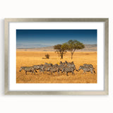 Textured art depicting an abstract African savannah scene in earthy tones on a framed silver mat, suitable for bedroom decor.