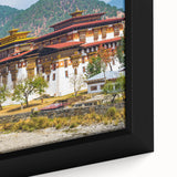 Extra large black wall art featuring a textured, colorful Bhutanese landscape on framed canvas, ideal for living room decor.
