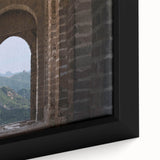 Close-up of textured black wall art depicting the Great Wall of China on a framed canvas, with colorful accents.