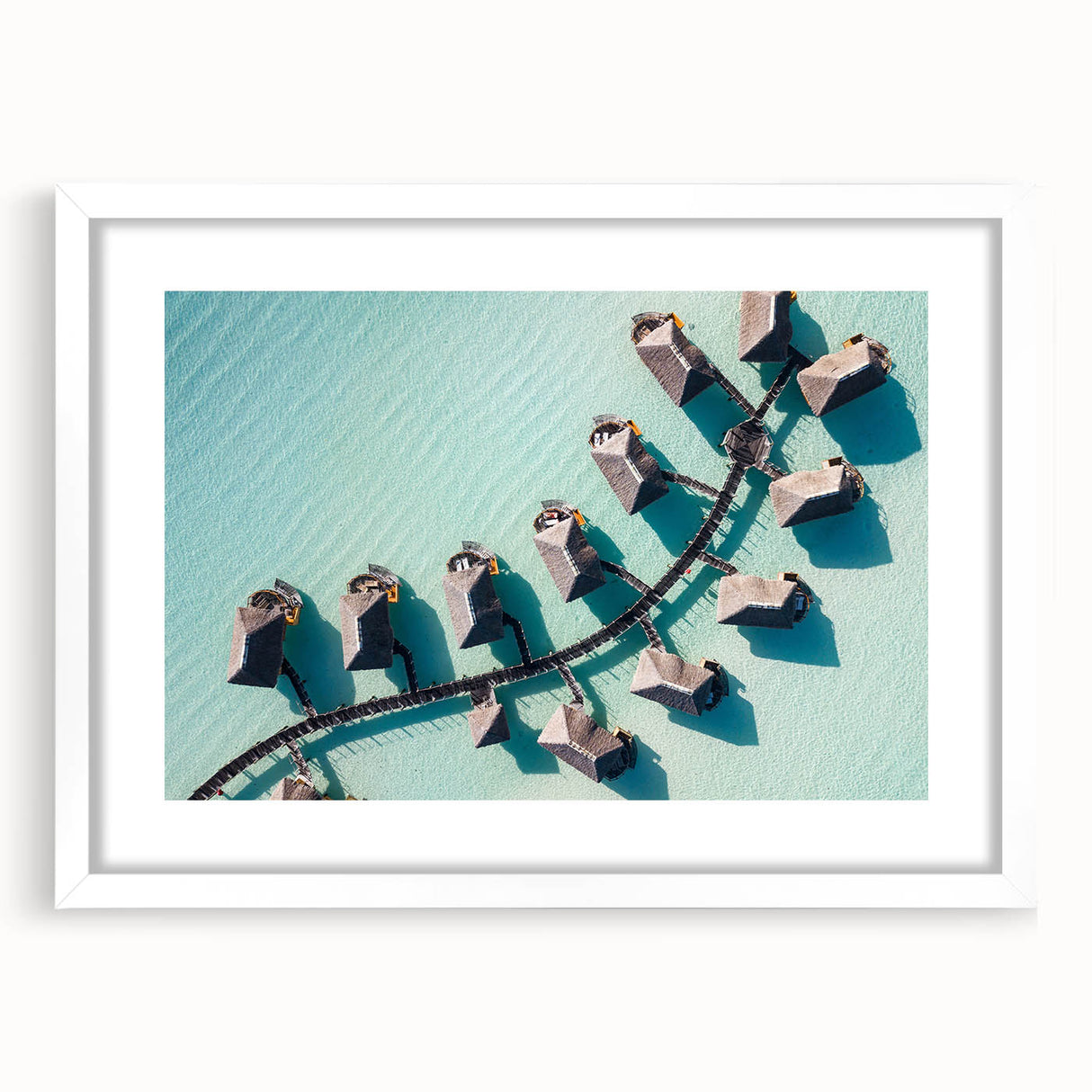 Abstract art print of Maldives scenery in muted blue and white tones on a framed poster.