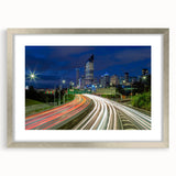 Abstract art print of Brisbane skyline in muted blue and gray tones on a framed silver mat, suitable for dining room decor.