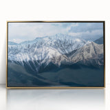 Large art print of British Columbia scenery in gold frame on acrylic, featuring muted green and blue tones.