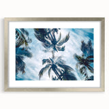 Abstract art print of Caribbean scenery in muted blues and greens on a framed silver mat, ideal for dining room decor.
