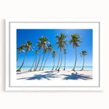 Textured abstract art print depicting Caribbean scenery in muted blue and green tones on a framed white mat.