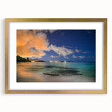 Abstract art print of a Caribbean scenery in muted blue and green tones, framed in gold, suitable for dining room decor.
