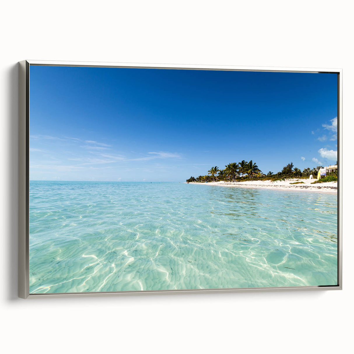 Framed canvas depicting a Caribbean landscape in vibrant colors, ideal for brightening a living room wall.