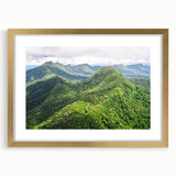 Abstract art print depicting a serene Belizean landscape in soft blue and green tones, framed in gold.