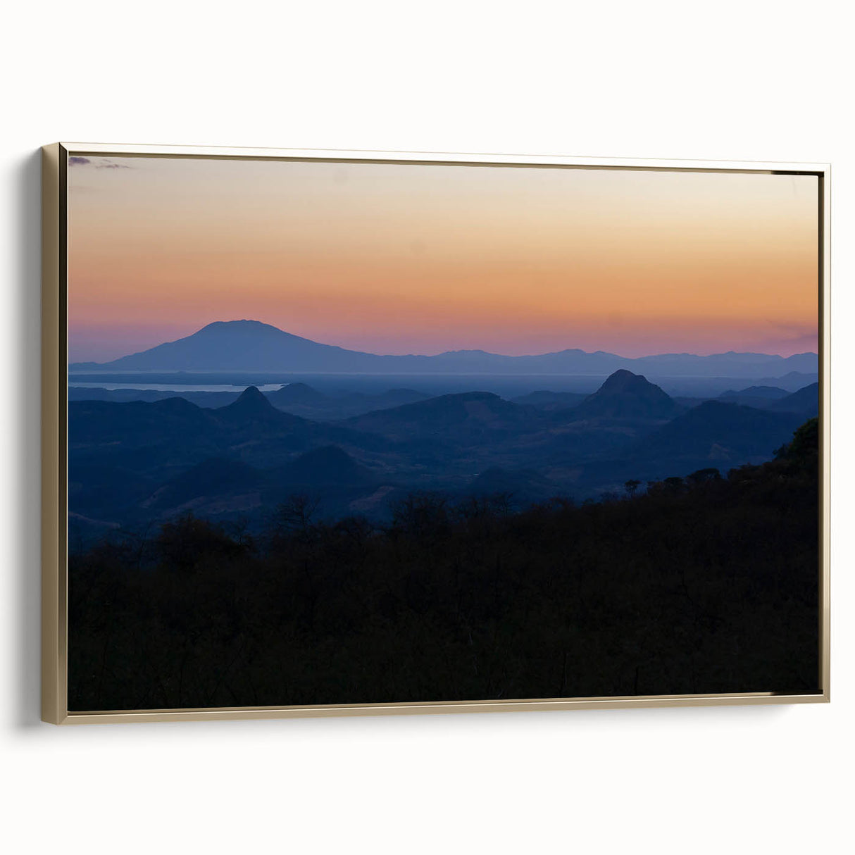 Framed canvas featuring a vintage-style landscape painting of a Central American scenery in black and gold tones.