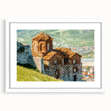 Abstract art print of a European scenery in muted earth tones on a white framed mat, ideal for dining room decor.