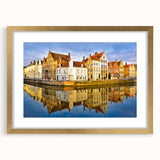 Abstract art print of a European scenery in muted gold and green tones, framed with a gold mat.