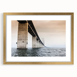 Abstract art print of a European scenery in muted gold and green hues, framed with a gold mat.