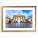Abstract art print of Berlin skyline in muted gray and blue tones, framed in gold, ideal for dining room decor.