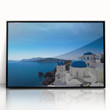 Large abstract wall art depicting the Santorini shoreline in muted blue and white tones, framed in black acrylic.