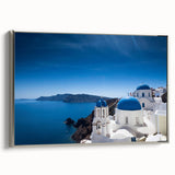 Framed canvas of a vintage-style Santorini landscape painting in vibrant blue and white tones, ideal for living room decor.