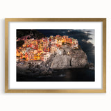Abstract art print of Cinque Terre with vibrant blue and pastel hues on a gold-framed canvas, suitable for dining room decor.
