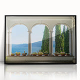 Large abstract wall art of Lake Como with muted blue and green tones, framed in black acrylic.
