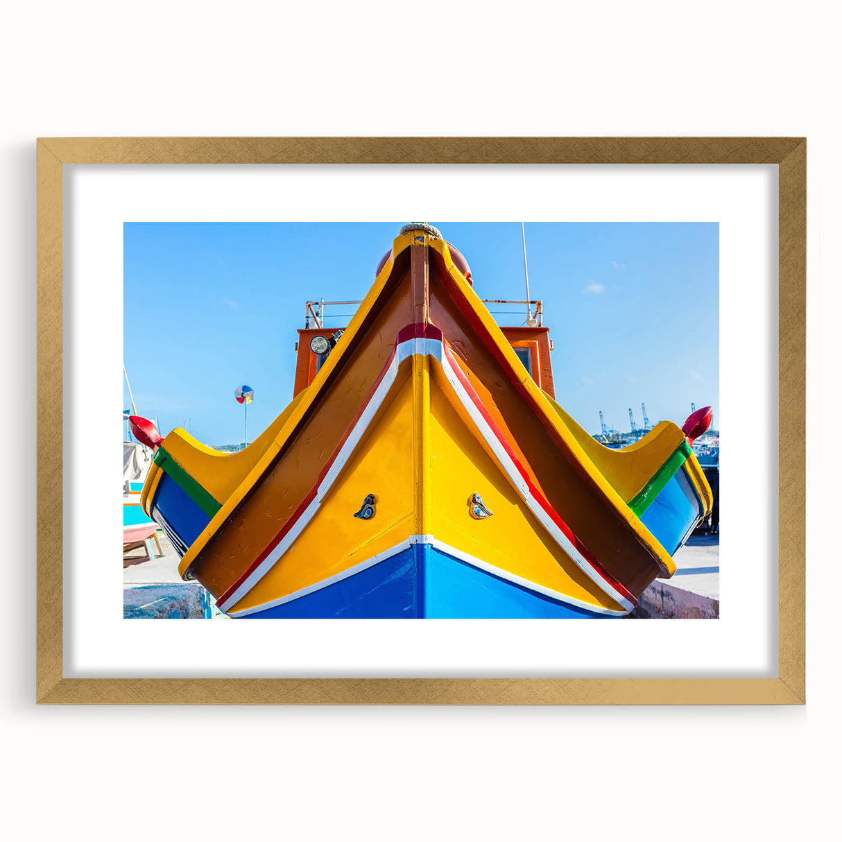 Abstract art print of a European Malta scenery in muted gold and blue tones, framed with a gold mat.