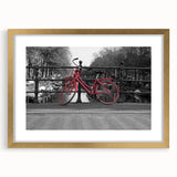 Abstract art print of Amsterdam canals in muted gold and blue tones, framed with a gold mat, ideal for dining room decor.