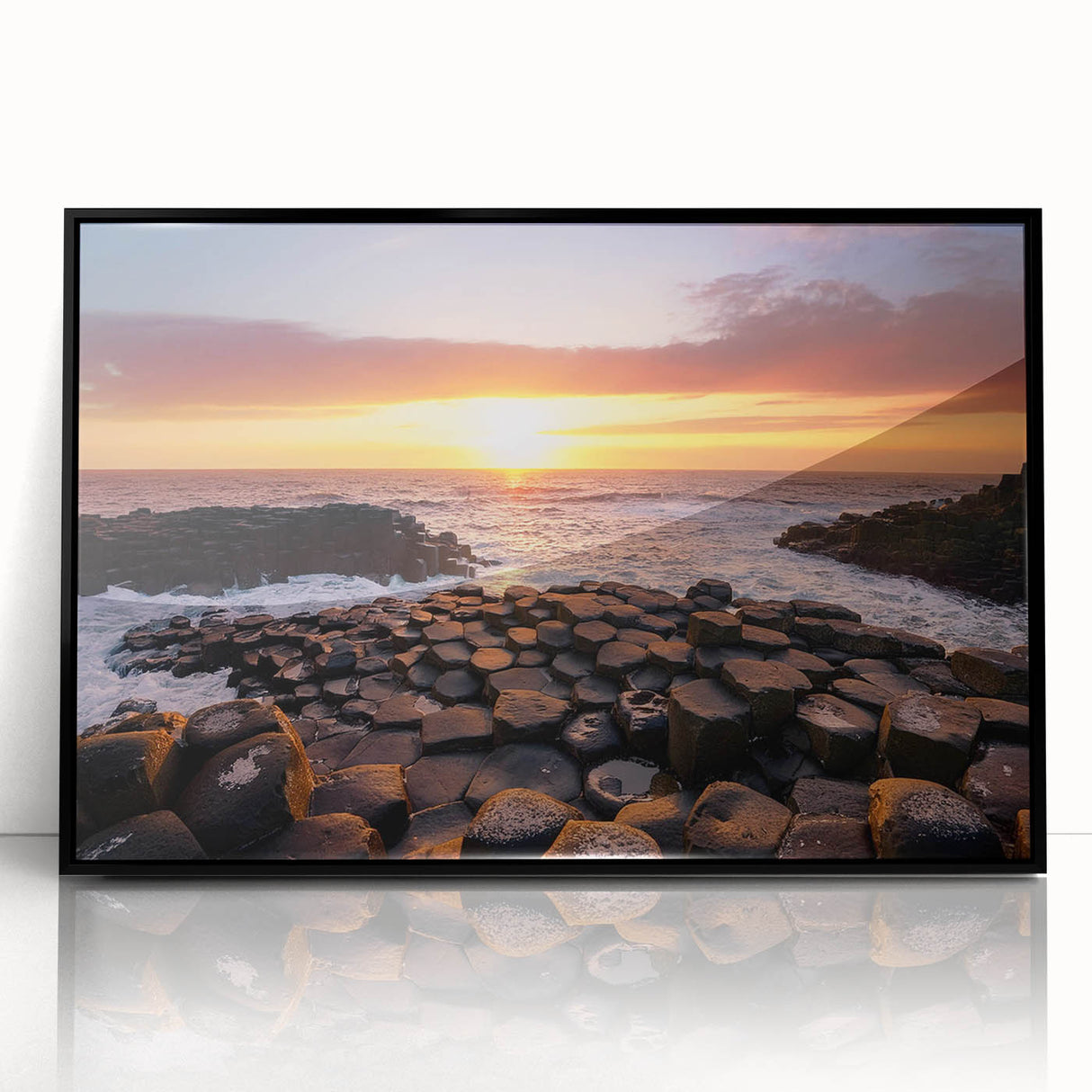 Large abstract wall art depicting a Northern Ireland scenery in muted green and blue tones, framed in black acrylic.