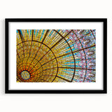 Colorful abstract art print of Barcelona scenery on textured canvas, framed in black, ideal for living room decor.