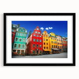 Abstract art print of Stockholm scenery in vibrant colors on a textured, extra large canvas, framed in black.
