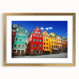 Extra large abstract art print of Stockholm scenery in muted gold and blue tones, framed with mat.