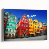 Framed canvas featuring a vintage-style landscape painting of Stockholm, with vivid colors on a black background.