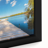 Close-up of a framed canvas depicting a textured European scenery, with a black border and vibrant colors.