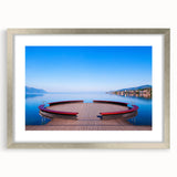 Textured art depicting abstract scenery of Geneva in muted gray and blue tones, framed with a silver mat.