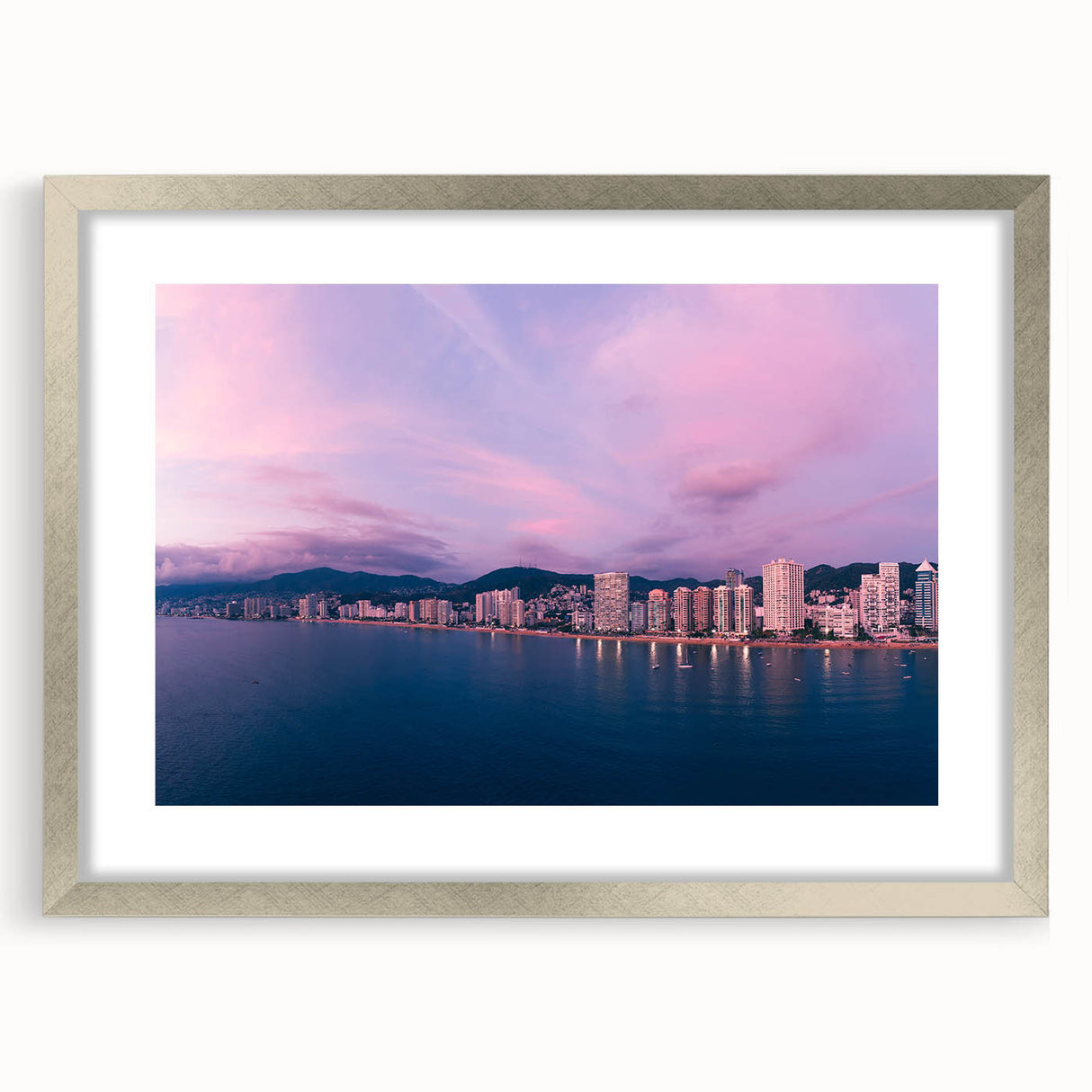 Textured abstract art print of Acapulco scenery in muted earth tones, framed in silver, ideal for bedroom decor.