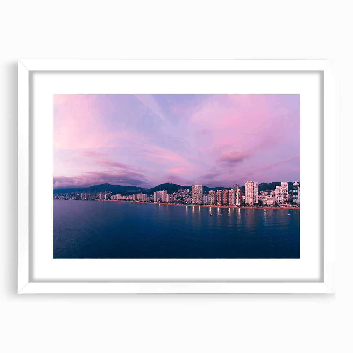 Abstract art print of Acapulco scenery in muted blue and green tones, framed with a white mat, ideal for dining room decor.