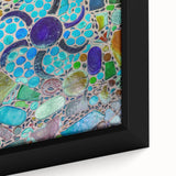 Close-up of textured black wall art depicting Cabo San Lucas scenery on a framed canvas, featuring vibrant colors.