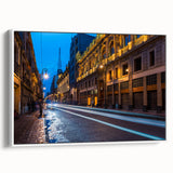 Vintage poster art of Mexico City on a framed canvas, featuring colorful buildings on a black background.