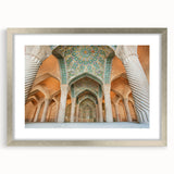 Textured art depicting abstract Middle Eastern scenery in muted earth tones on a framed silver mat.